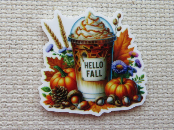 First view of Yummy looking pumpkin flavored drink with pumpkins, acorns, a pinecone, fall leaves and flowers surrounding it minder.