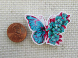 Second view of half blue butterfly and half blue flowers needle minder.