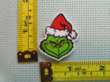 Third view of the Grinch in a Santa Hat Needle Minder