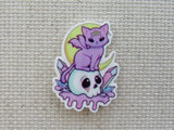 First view of Purple Bat Cat Sitting on a Skull Needle Minder.