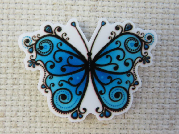 First view of Blue and Black Swirl Butterfly Needle Minder.