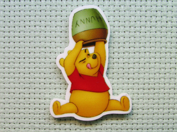 First view of the Pooh Trying to Get the Last Drop Of Honey out of the Honey Pot Needle Minder