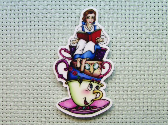 First view of the Belle Reading a Book on a Stack of Teacups Needle Minder