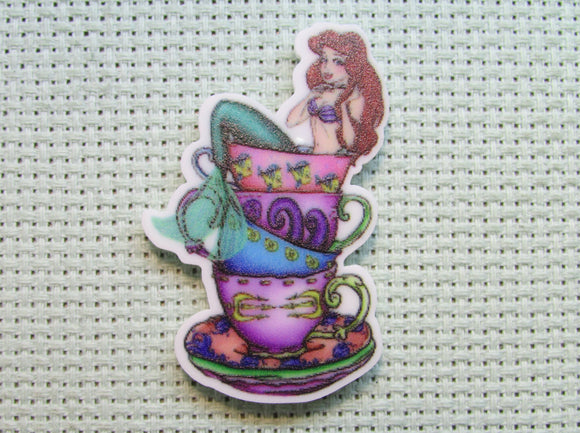 First view of the Ariel Sitting on a Stack of Teacups Needle Minder