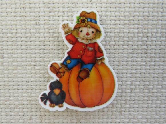 First view of Scarecrow Sitting on Top of a Pumpkin with a Crow Friend Needle Minder.
