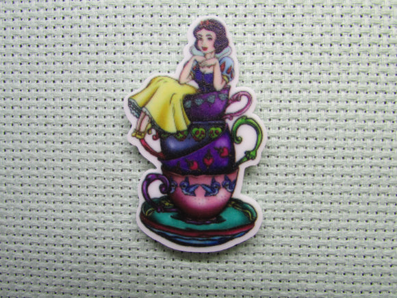 First view of the Snow White Sitting on a Stack of Teacups Needle Minder