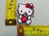 Third view of the Cute White Kitty with a Strawberry Needle Minder