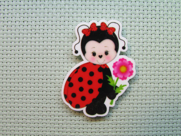 First view of the Adorable Flower Holding Lady Bug Needle Minder