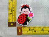 Third view of the Adorable Flower Holding Lady Bug Needle Minder