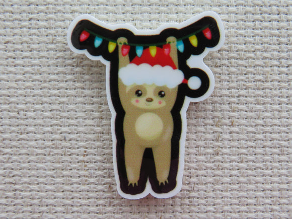 First view of Christmas Sloth Hanging From a String of Lights Needle Minder.