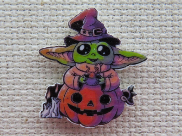First view of Grogu Sitting in a Jack O Lantern Needle Minder.