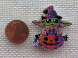Second view of Grogu Sitting in a Jack O Lantern Needle Minder.