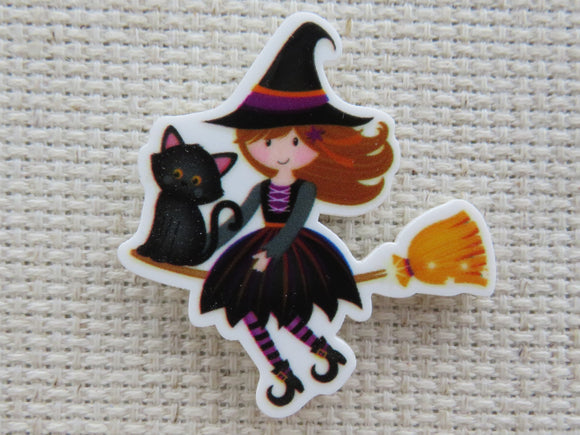 First view of Cute Young Witch Riding on a Broom with a Black Cat Needle Minder.