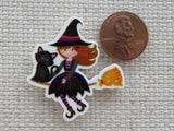 Second view of Cute Young Witch Riding on a Broom with a Black Cat Needle Minder.