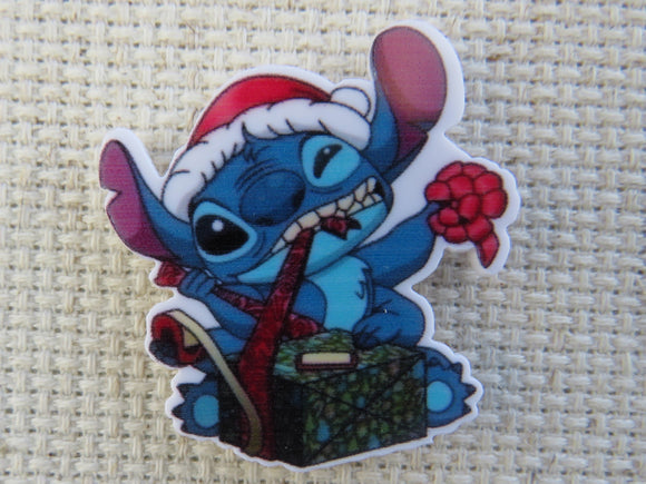 First view of Stitch Tearing Open a Christmas Gift Needle Minder.