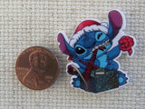 Second view of Stitch Tearing Open a Christmas Gift Needle Minder.