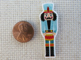 Second view of Blue Drumming Nutcracker Needle Minder,.