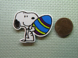 Second view of the Snoopy Holding an Easter Egg Needle Minder