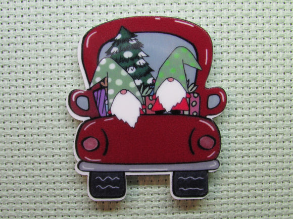 First view of the A Couple of Gnomes in the Back of a Red Truck with a Tree Needle Minder