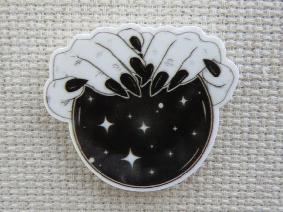 First view of Magical Hands on a Black Crystal Ball Needle Minder,.