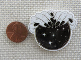 Second view of Magical Hands on a Black Crystal Ball Needle Minder,.