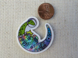 Second view of Space Dinosaur Holding a Star Needle Minder.