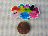 Second view of A Pile of Plush Octopus Needle Minder.
