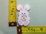 Third view of the Easter Bunny Holding a Pretty Flower Easter Egg Needle Minder