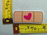 Third view of the All Better With Love Band aid Needle Minder