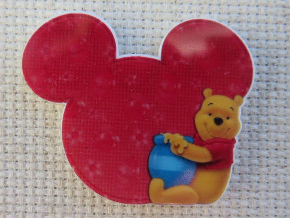 First view of Pooh Bear Sitting Next to Red Mouse Ears Needle Minder.