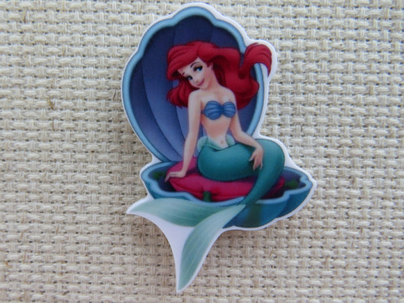 First view of Ariel Sitting in a Shell Needle Minder.
