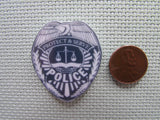 Second view of the Police Shield Needle Minder