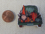 Second view of gnome in the back of a green truck needle minder.