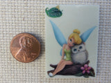 Second view of Tinkerbell is sitting on a log with an owl needle minder.