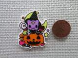 Second view of the Purple Cat Wearing a Witch's Hat in a Carved Pumpkin full of Candy in Front of a Moon Needle Minder