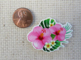 Second view of Beautiful pink hibiscus flowers with white plumeria and green leaves minder.