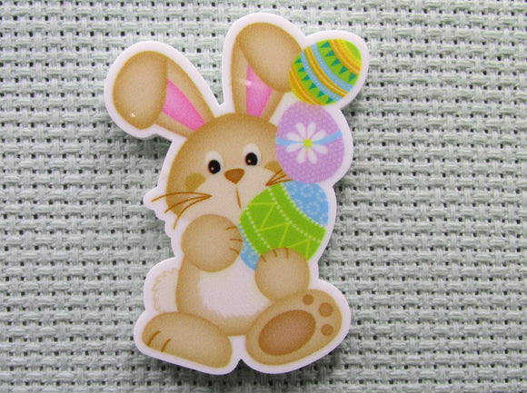 First view of the Tan Easter Bunny with a Stack of Colorful Eggs Needle Minder