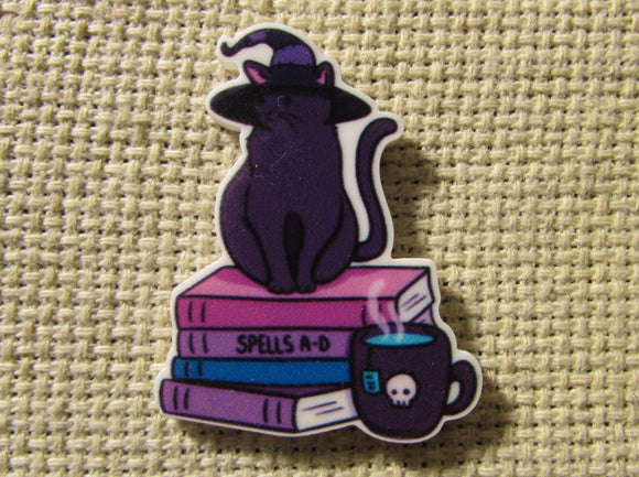 First view of the Purple Witch Cat Sitting on a Stack of Books Needle Minder