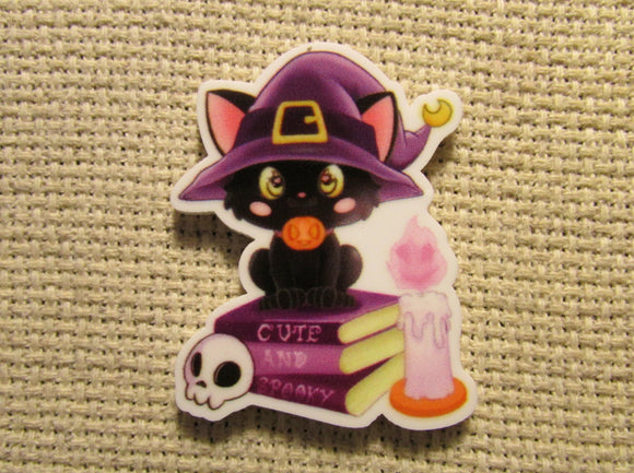 First view of the Black Cat Sitting on Spell Books Needle Minder