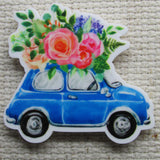 Up close view of Cute Blue Car with Beautiful Flowers on Top Needle Minder