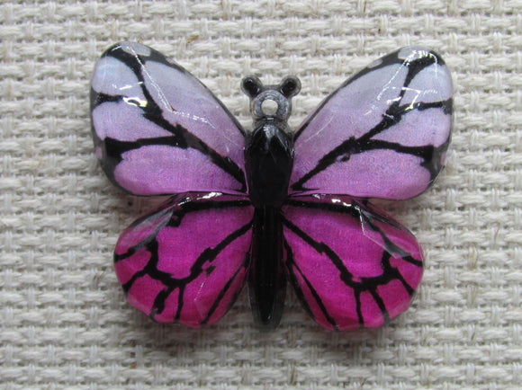 First view of a pink butterfly needle minder