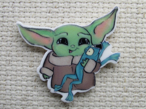 First view of Alien Child Playing with a Frog Needle Minder.