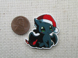 Third view of Toothless with a Santa hat needle minder.