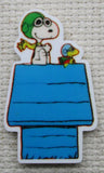 Close up view of Red Baron Snoopy on a Blue Doghouse Needle Minder.