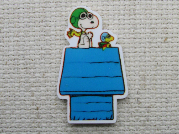 First view of Red Baron Snoopy on a Blue Doghouse Needle Minder.