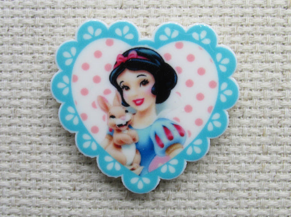 First view of Snow White with a Bunny in a Blue Fringed Heart Needle Minder.