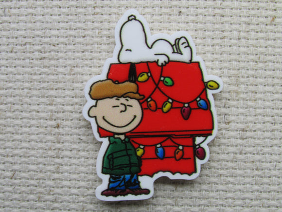 First view of Charlie Brown and Snoopy with a Doghouse Decorated for Christmas Needle Minder.