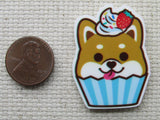 Third view of corgi cupcake needle minder.