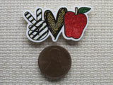 Second view of peace love apple/teacher needle minder.