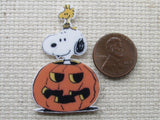 Second view of Snoopy popping his head out of the carved pumpkin needle minder.